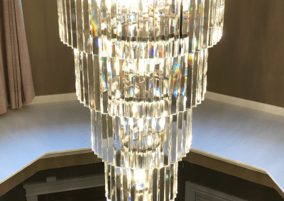 Image of a Crystal Chandelier Installation by Exquisite Electric