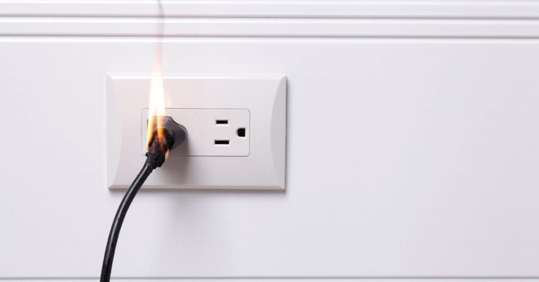 Electrical Outlet Fire Hazard image of an overheated electrical outlet on fire