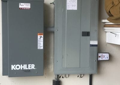 image of a kohler generator panel and an electrical panel with a surge protector