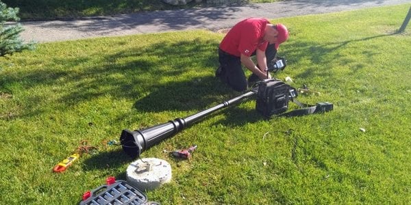 image of Commerial Electrician Dustin from exquisite electric fixing a lamp pole in High River