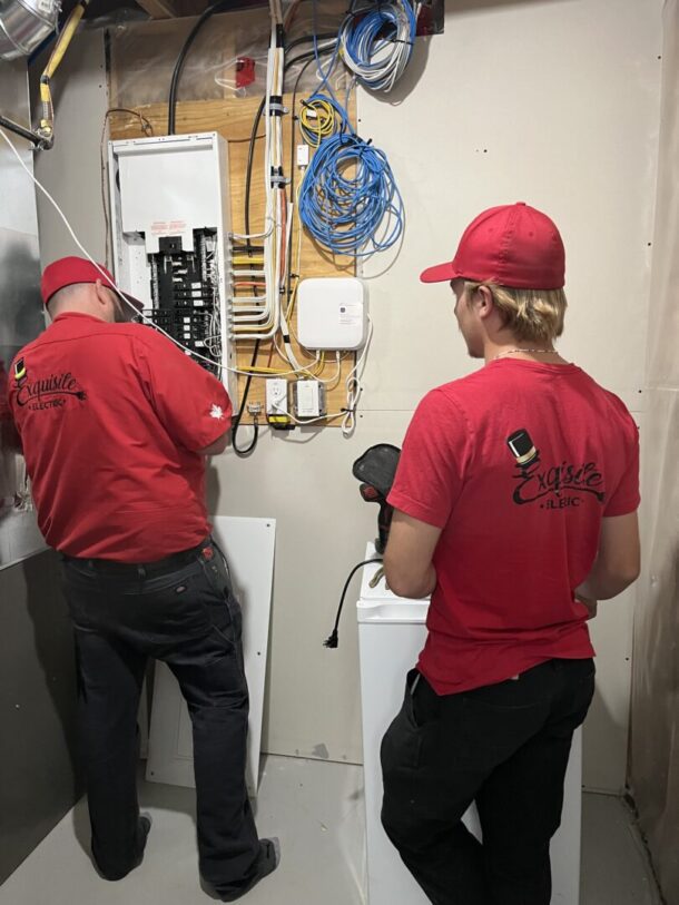 Calgary Electrician, Bryan Kenly, performs an electrical panel upgrade while his Okotoks electrician apprentice, Noah, assists.
